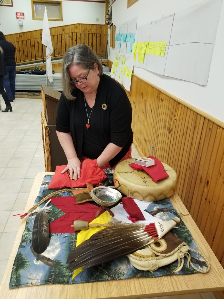 Knowledge Holder Prepping Medicine Bundles